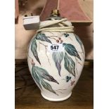 A C.H. Branham Barnstaple pottery vase with hand painted leaf and berry decoration on a white ground