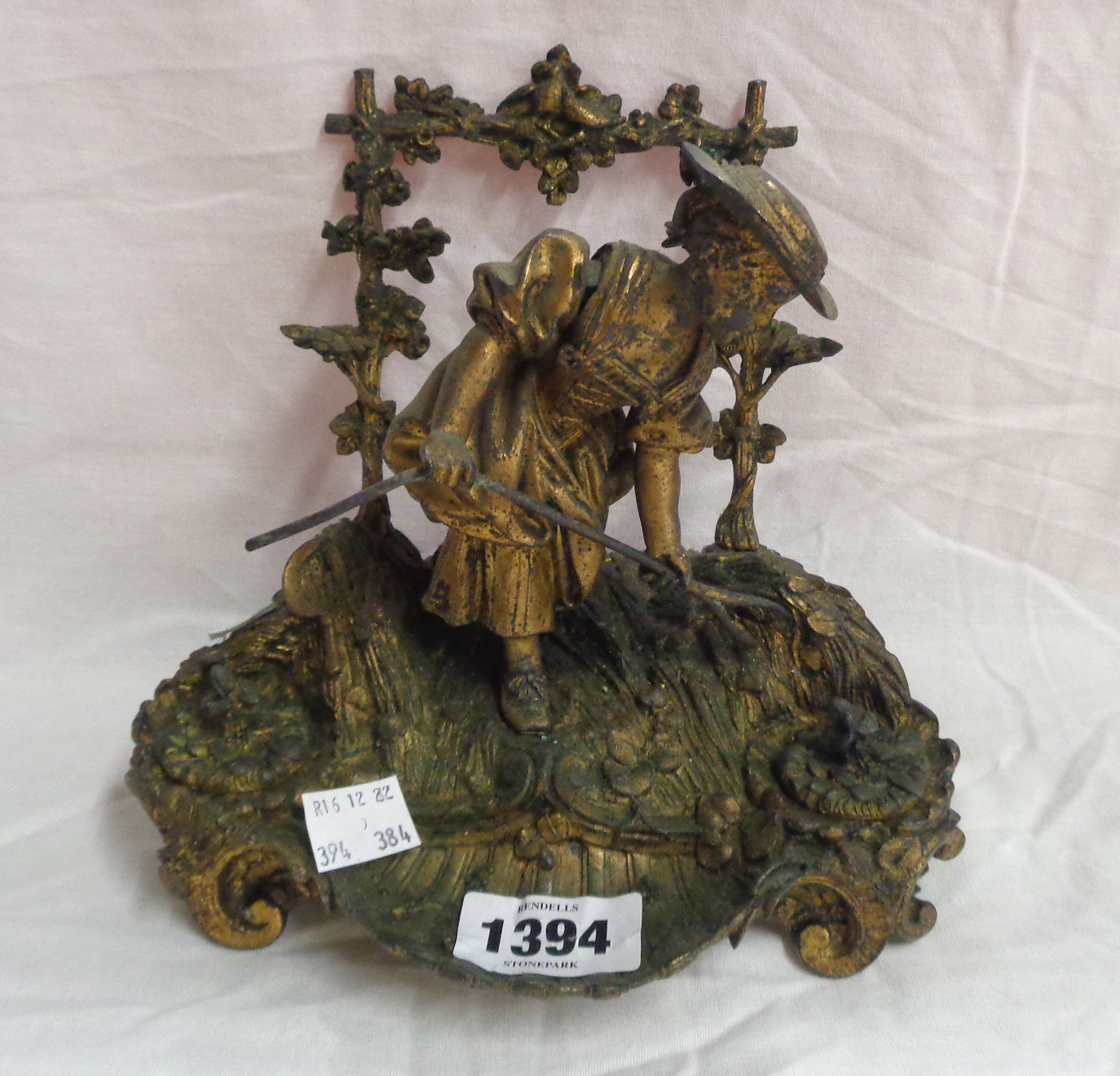 A late 19th Century ormulu figural desk inkstand depicting a young girl making hay with trellis