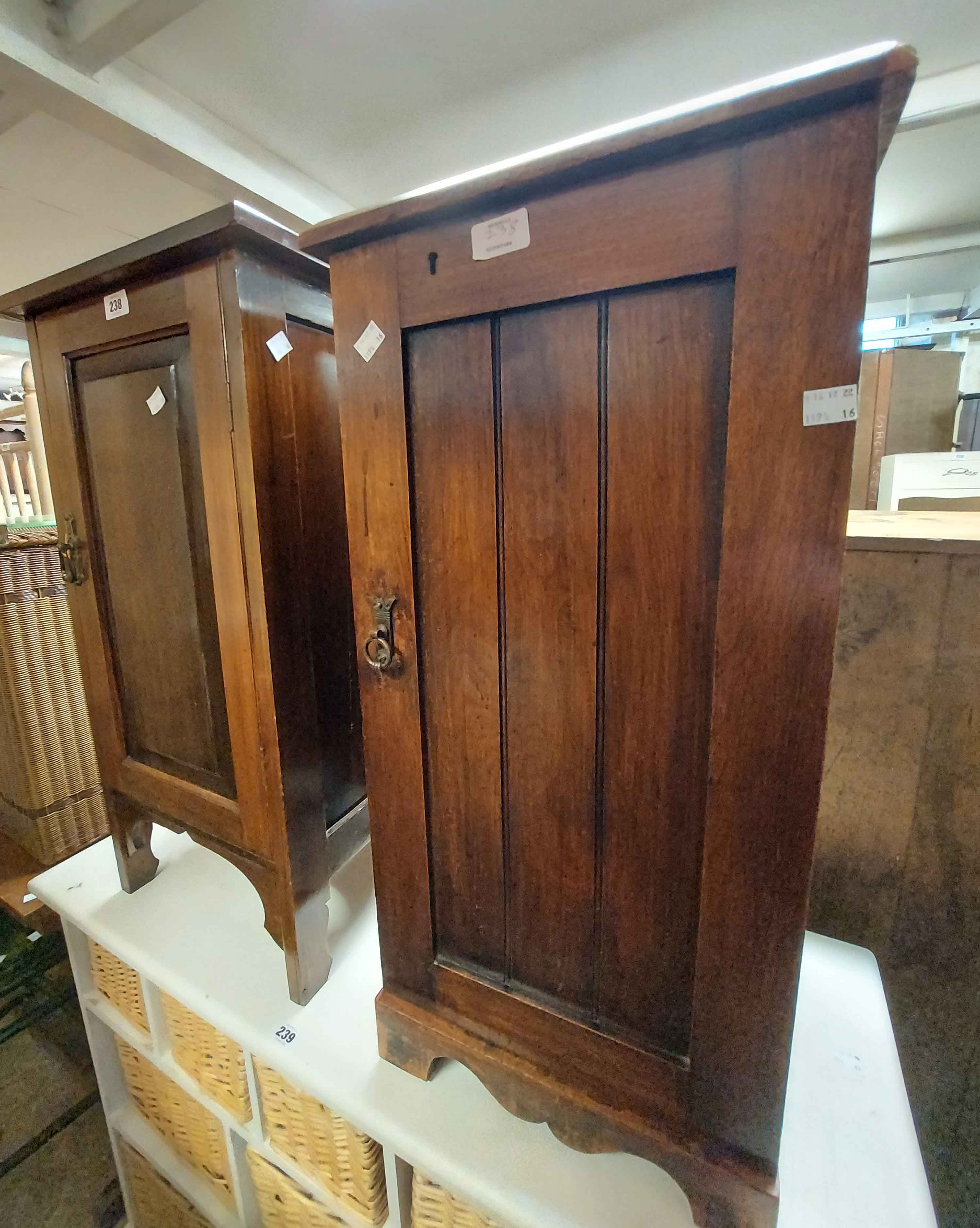 Two Edwardian walnut pot cupboards, both with shelves enclosed by a single panelled cupboard door