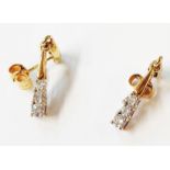 A pair of 375 (9ct.) gold drop earrings, each set with three small diamonds - boxed