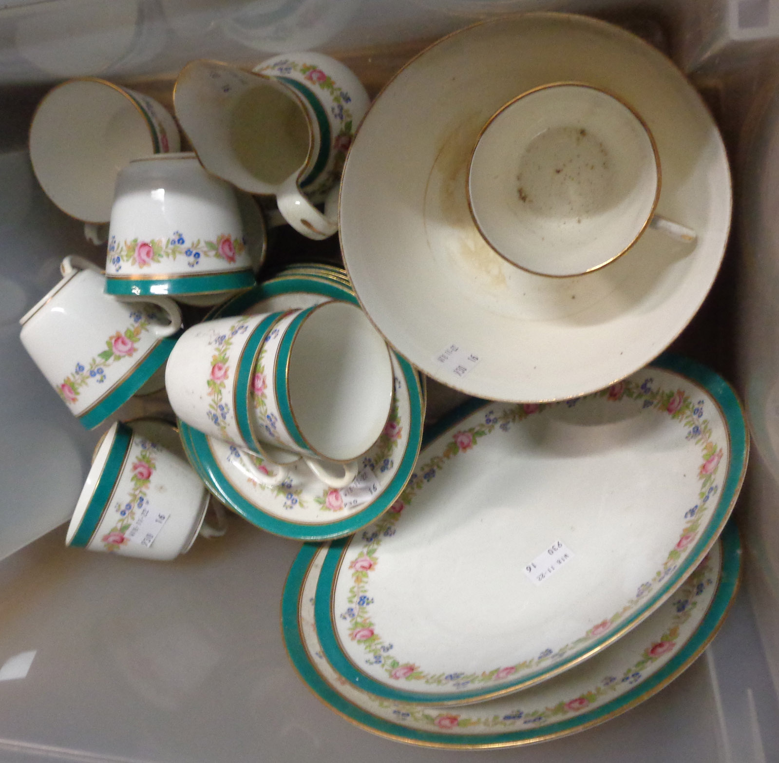 A late 19th Century bone china part tea set with hand painted floral sprays and a green banded