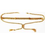 A 375 (9ct.) gold double tassel end neck chain - sold with a double rope-twist bracelet to match