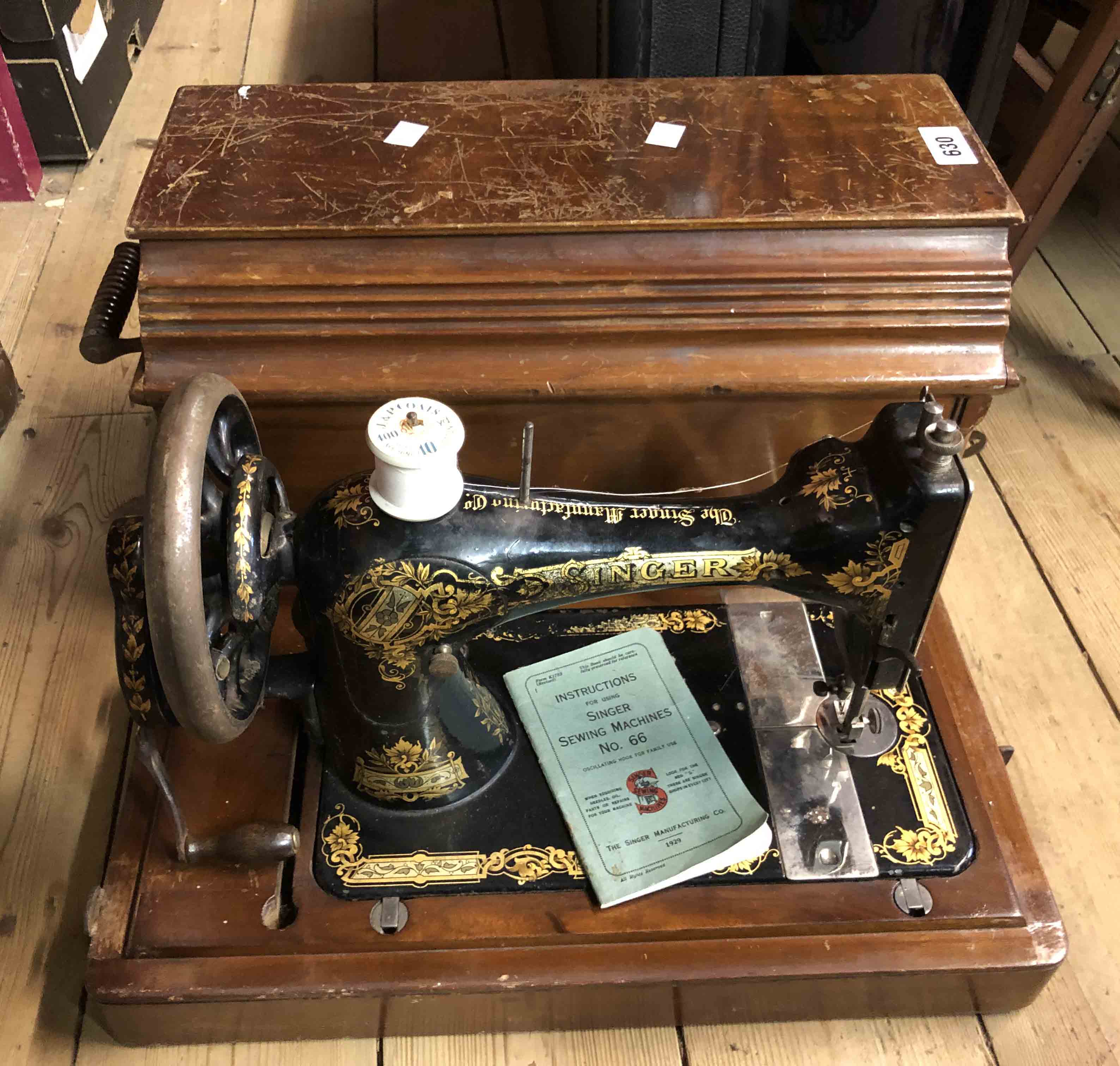 An old Singer sewing machine in wooden sarcophagus form case