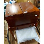 A mahogany sewing box with bi-folding top, set on stand base with frieze drawer and slender square