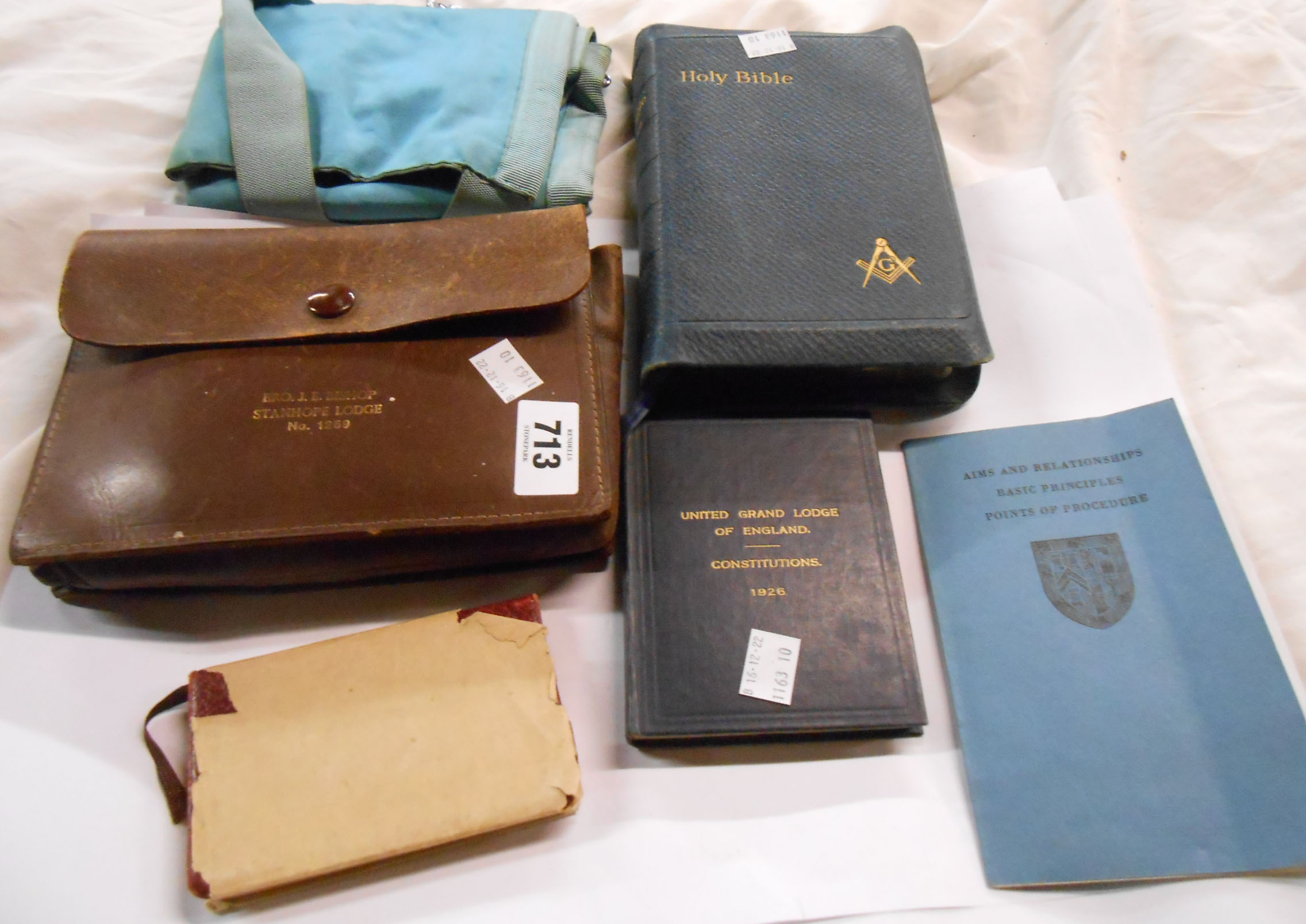 A quantity of Masonic related items including books, Bible, apron in original leather case, etc.