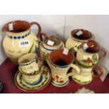 A selection of Torquay pottery mottoware including Longpark, HM Exeter, etc.