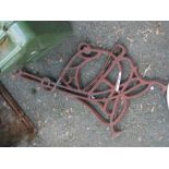 A pair of decorative cast iron bench ends of ornate pierced form