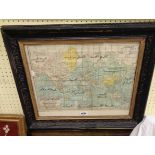 A framed old coloured map print of the world with Arabic text