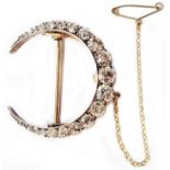 A 3.3cm late Victorian old cut diamond set crescent brooch with safety chain