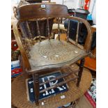 An old oak smoker's bow spindle back elbow chair with replacement seat panel, set on turned front