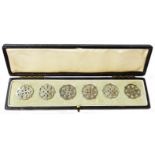 A cased set of six silver buttons with pierced decoration - London 1907