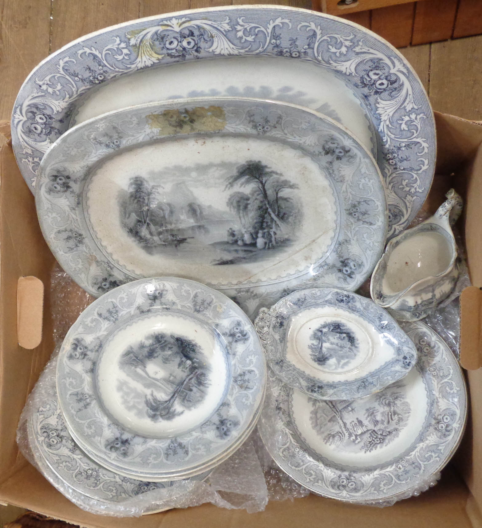 A box containing a quantity of 19th Century transfer printed dinner ware in the Lake pattern