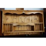 A 1.2m modern pine wall mounted pine open plate rack with shaped frieze to top