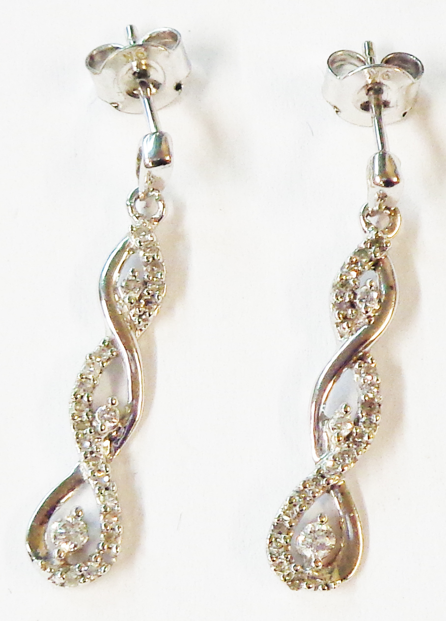 A pair of 375 (9ct.) white gold drop earrings of twist design, set with small diamonds - boxed