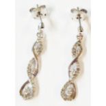 A pair of 375 (9ct.) white gold drop earrings of twist design, set with small diamonds - boxed