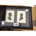 A pair of 19th Century silhouette portraits of a man and woman in one frame