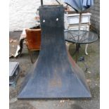 A large black painted metal fire hood