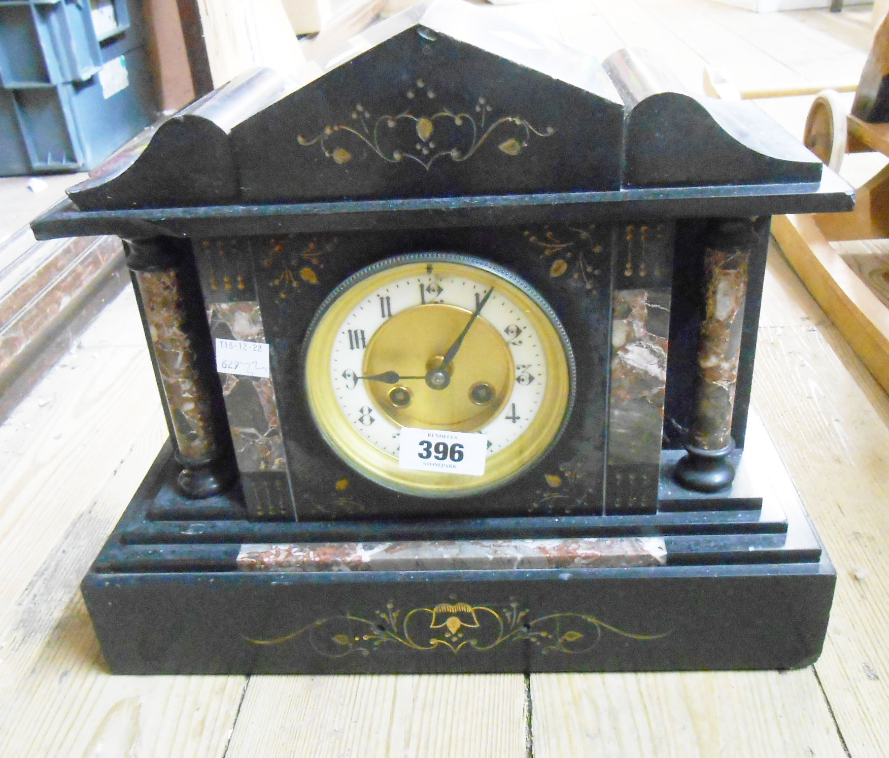 A late Victorian black slate and marble cased mantel clock of architectural design with Richard et