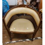 An Edwardian inlaid mahogany framed tub chair with lathe sides and upholstered top rail and seat,