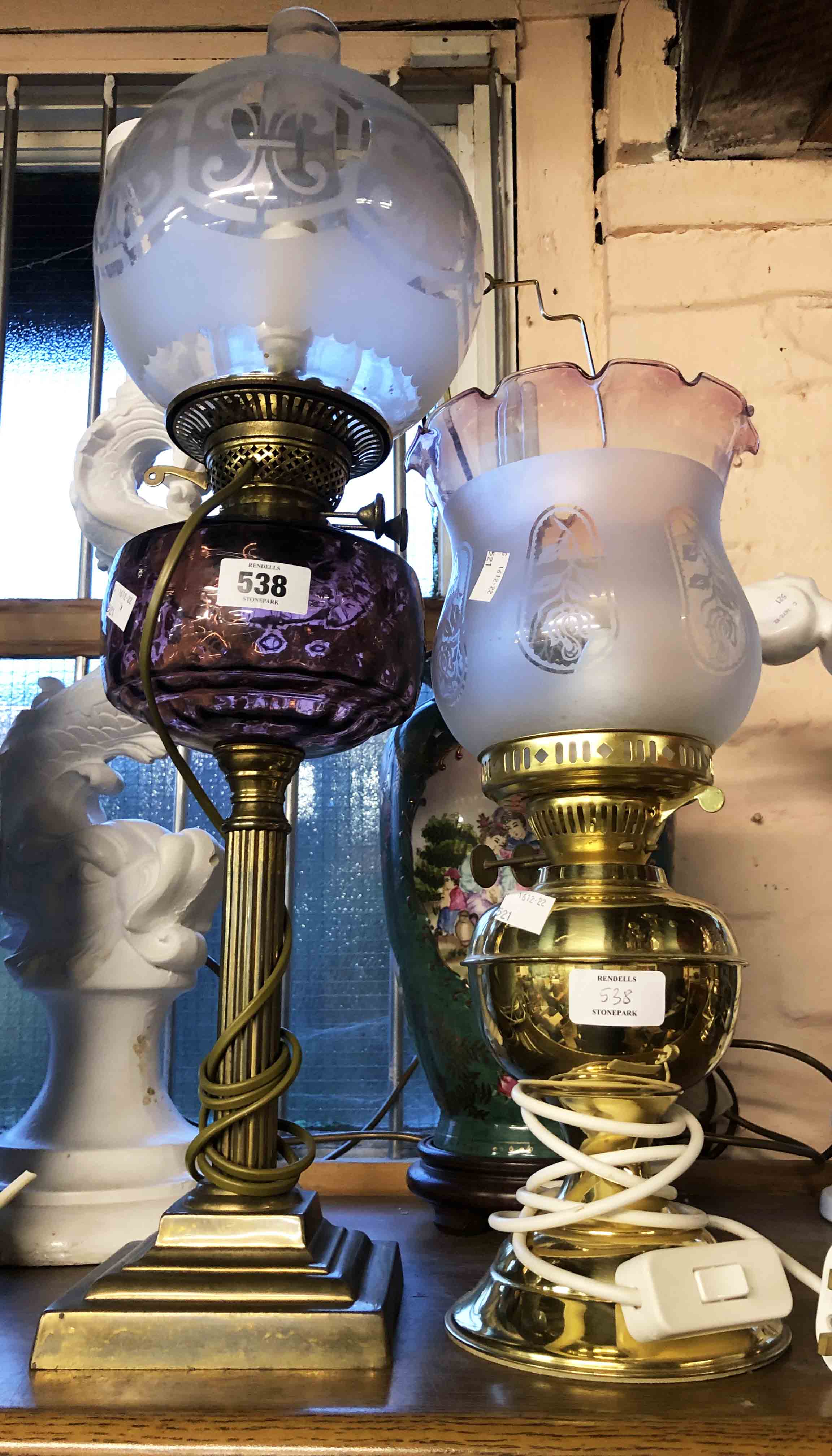 A Victorian Duplex oil lamp with amethyst glass shade, set on brass Corinthian column base with