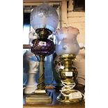 A Victorian Duplex oil lamp with amethyst glass shade, set on brass Corinthian column base with