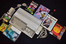 A COMMODORE AMIGA A500 PLUS VINTAGE COMPUTER with an A520 plug in, a QJ1 Joystick and seven