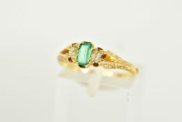 A LATE VICTORIAN EMERALD AND DIAMOND THREE STONE RING, the central baguette cut emerald flanked by