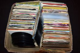 A TRAY CONTAINING APPROX TWO HUNDRED AND FIFTY 7in SINGLES artists include Elvis Presley, Simon