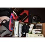 A TRAY OF GAMING CONSOLES AND GAMES and a tray containing bags and cases, the consoles include two