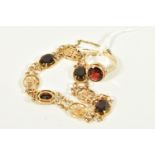 A GARNET RING AND BRACELET, the ring designed as an oval garnet in a collet setting to the pierced