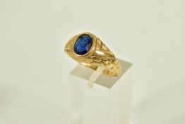 A 9CT GOLD SIGNET RING, set with an oval cut blue stone assessed as paste (loose in setting),