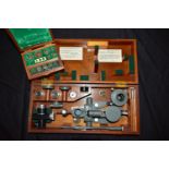 A THOMAS COOKE AND SONS VINTAGE MICRO HARDNESS TESTER in a mahogany case Serial No M06237 along with