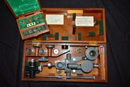 A THOMAS COOKE AND SONS VINTAGE MICRO HARDNESS TESTER in a mahogany case Serial No M06237 along with