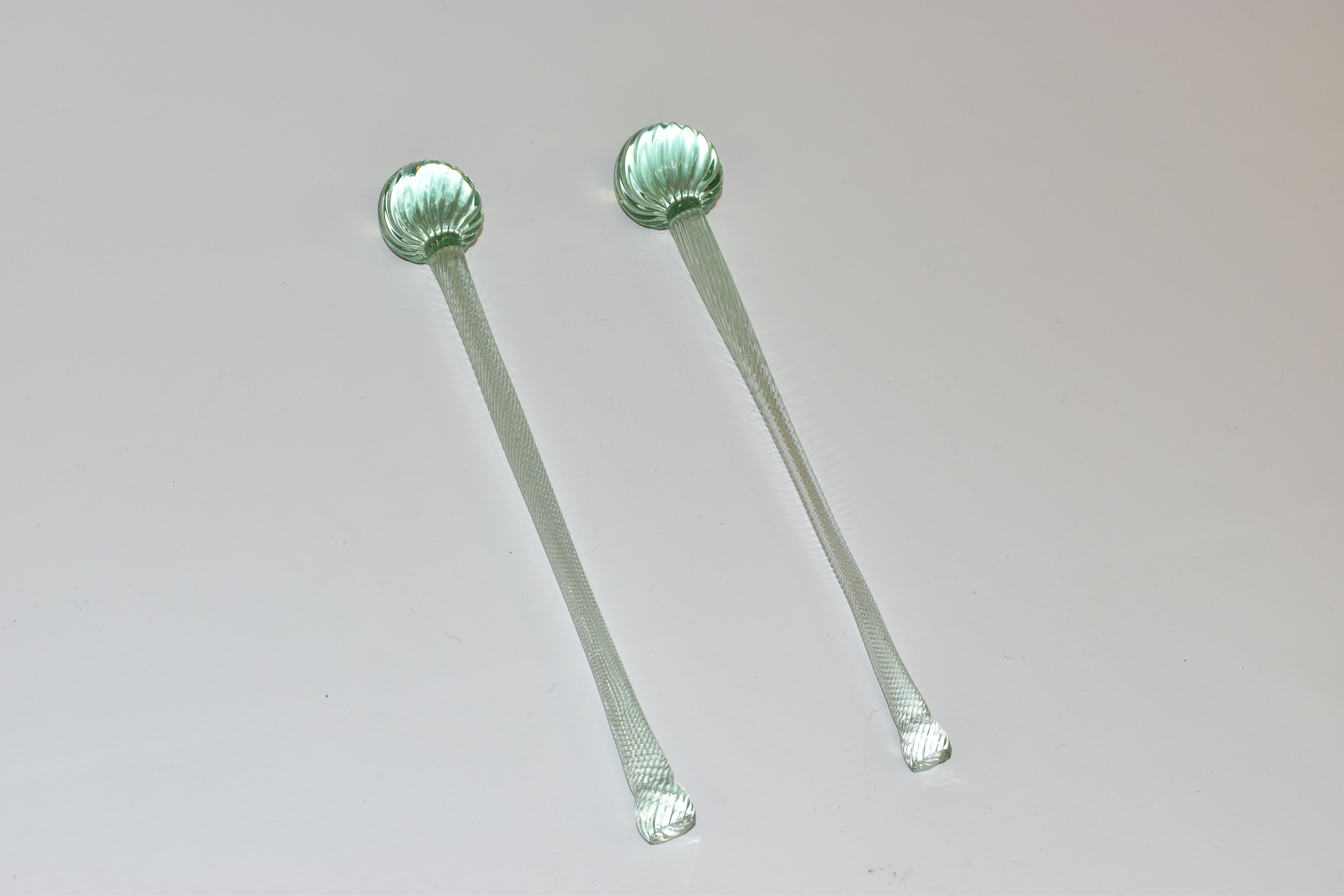 A NEAR PAIR OF NAILSEA GLASS DRUM STICKS, with wrythen twist design, longest length 33cm (2) (