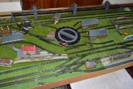 A SUBSTANTIAL OO GAUGE MODEL RAILWAY TRACK LAYOUT, consisting of track, buildings and accessories,