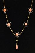 A YELLOW METAL ONYX AND CORAL NECKLACE, designed with five circular onyx disks, each set with a