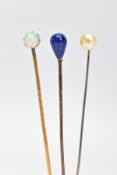 THREE GEMSET STICKPINS, to include one yellow metal stickpin set with a single claw set opal, a
