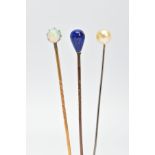 THREE GEMSET STICKPINS, to include one yellow metal stickpin set with a single claw set opal, a