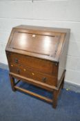 AN OAK FALL FRONT BUREAU, with two drawers, width 77cm x depth 44cm x height 100cm