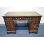 A MAHOGANY TWIN PEDESTAL DESK, with a green leather skiver, over nine drawers, width 122cm x depth