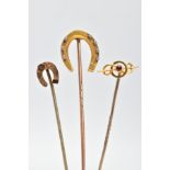 THREE LATE 19TH TO EARLY 20TH CENTURY STICKPINS, to include one horse shoe stickpin with floral