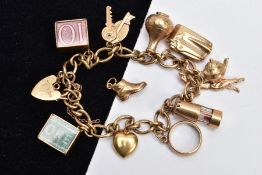 A 9CT GOLD CHARM BRACELET, curb link bracelet suspending ten charms in forms such as a lamp,