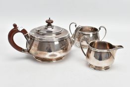 A THREE PIECE SILVER TEA SET, to include a silver round teapot with a brown insulated handle,
