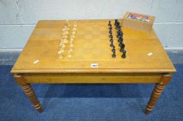 AN OAK CHESS COFFEE TABLE, width 76cm x depth 49cm x height 45cm, with a box of chess pieces