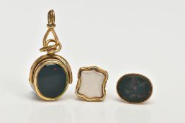 THREE HARDSTONE FOBS, the first a carved intaglio, the shield shape chalcedony panel engraved with