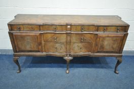 A MID TO LATE 20TH CENTURY WALNUT AND CROSSBANDED QUEEN ANNE SIDEBOARD, with a shaped top, two short