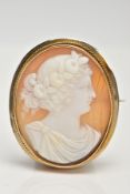A YELLOW METAL CAMEO BROOCH, of an oval from, depicting a lady in profile, collet mount with a