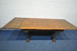 AN OAK DRAW LEAF TABLE, with a parquetry top, on acorns supports united by a floor stretcher,