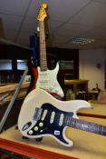 TWO STRAT TYPE ELECTRIC GUITARS one by Samick in Ivory with a black scratchplate, white pickups