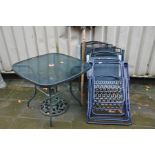 A GLASS TOPPED GARDEN TABLE 88cm square, two pairs of folding chairs and a parasol